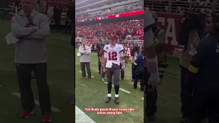 Tom Brady greets Bryant Young right before taking field