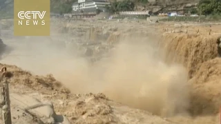 Downpours swell China’s Hukou Waterfall