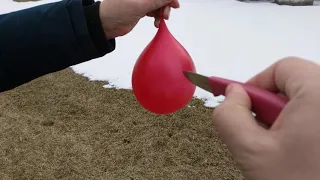 Phone footage of a balloon popping in slow motion