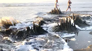 sandcastle destroyed by a wave