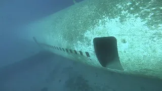 Underwater plane wreck freediving inside passenger cabin of The Lockhead L-1011 TriStar plane.