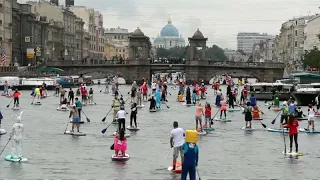 Paddleboard masquerade brings colours to St. Petersburg canals