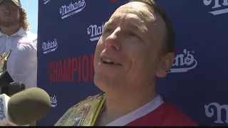 Joey Chestnut Wins 15th Mustard Belt, Takes Down Protestor