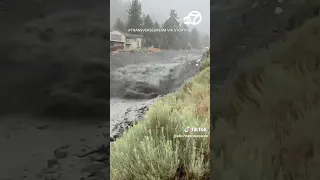 Locals watch as mud flows through CA canyon