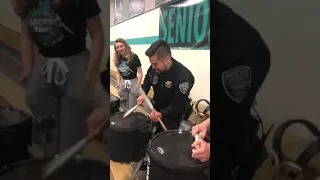 School Police Officer playing Snare at NVHS Basketball Game