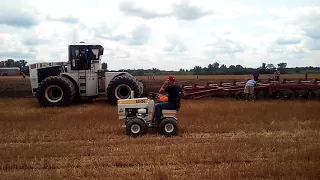 Big Bud 525 pulling 18 bottom plow