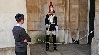 PECULIAR TOURIST stands and tries to STARE OUT the King's Guard Gatesman at Horse Guards!