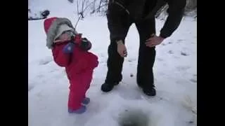 Cute baby girl catches her first fish in Alaska