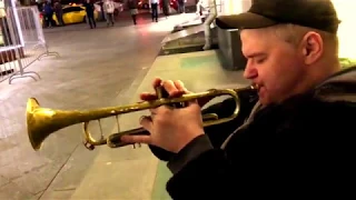 Street musician beautifully plays the trumpet Summertime