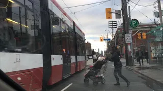 Woman unsuccessfully tries to get on TTC Streetcar whilst pushing a baby stroller.