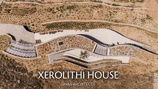 Snaking Stone House Embedded in the Hills of a Greek Island