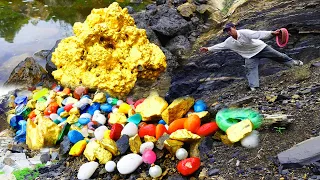 Gold nuggets and emeralds emerge from crevices in rocks after torrential rain.