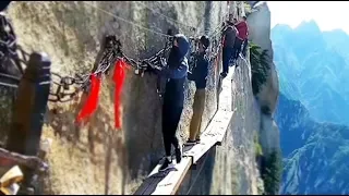 Daring workers change cliffside planks at Huashan Mountain