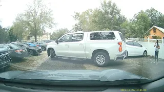 Florida Woman trying to hold parking spot by standing in it