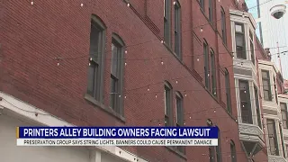 Printers Alley building sued for modern signs, banners