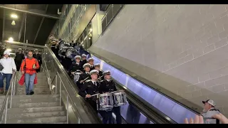Navy Drumline rides escalator