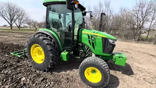 John Deere 4075R pulling cultivator/chisel plow