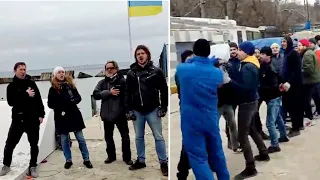 Ukrainian opera performers sing the national anthem while volunteers help prepare for Russian attack