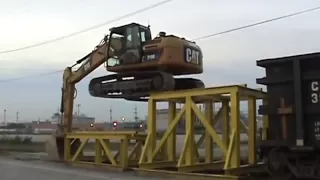 Cat 319D LN climbing onto rail car