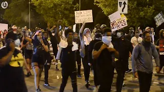 Protesters march through uptown on Sunday night