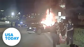 Officers pull unconscious man from burning car after crash | USA TODAY