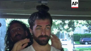 Men with long hair learn how to 'sport the bun'