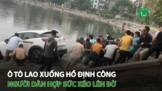 Ô tô l.a.o xuống hồ Định Công, người dân hợp sức kéo lên bờ | VTC14