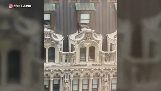 Caught on video: Man in suit jumps across high-rise rooftop about 23 stories above NYC