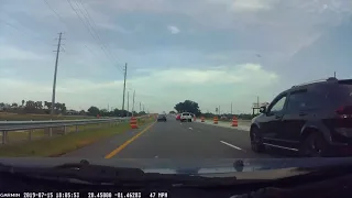 Driver makes left turn from right lane across two lanes of traffic and through red light.