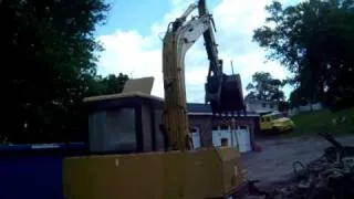 Cat E 70B loading a dumpster during a demolition project