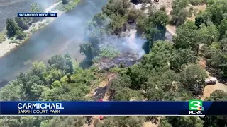 Vegetation fire burns along American River in Carmichael, threatens homeless encampments