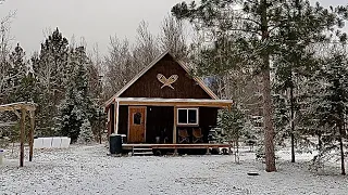 Building A Log Cabin In The Woods: Setting The First Row Of Logs