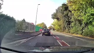 Absolute idiot overtaking traffic waiting at traffic lights.