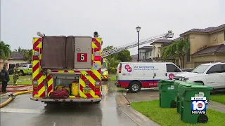 Roof fire possibly ignited by lightning strike in southwest Miami-Dade