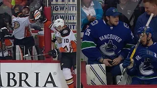 Thatcher Demko, Ryan Miller snag loose pucks on the bench