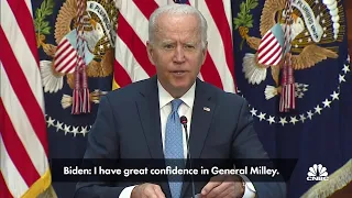 President Joe Biden stands behind General Milley