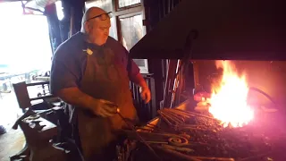 Forging a snub end scroll by blacksmith from Ireland finín liam Christie