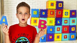 Mark looks for letters and opens boxes with surprises to learn the alphabet