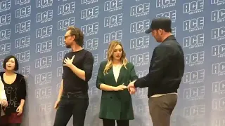 Elizabeth Olsen, Tom Hiddleston, and Chris Evans doing group photos at ACE