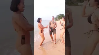 While calling to action, three young friends are fully dancing on the beach.