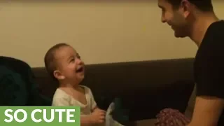 Baby laugh hysterically at dad's funny antics