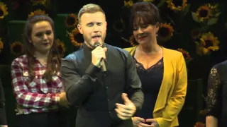 Gary Barlow on stage with 'The Girls'