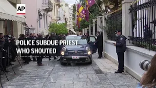 Police subdue priest who shouted 'heretic' at Pope