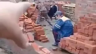 A group of drunk Russians building a brick wall