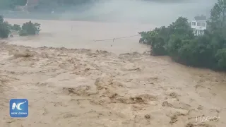 Armed police rescue people from flash floods in SW China