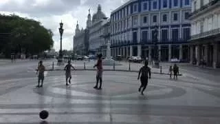 Group of boys playing football at Paseo del Prado in Havana, Cuba