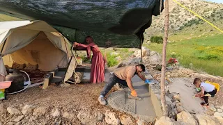 "An energetic couple performing the beauty of cement work on the floor of the nomadic canopy"