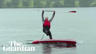 Liberal Democrat leader Ed Davey slips off paddleboard into lake