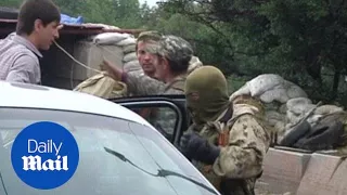 Pro-Russian separatist fighters man a checkpoint in Donetsk - Daily Mail