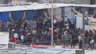 People take aid from trucks in Rafah in the Gaza Strip